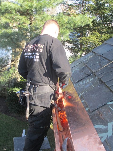 Copper gutter liner installed inside existing wood gutters to improve durability and prevent leaks.