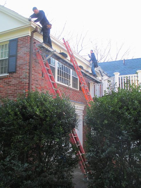 Landmark Roofing installing copper gutter liner in wood gutters for better water management.