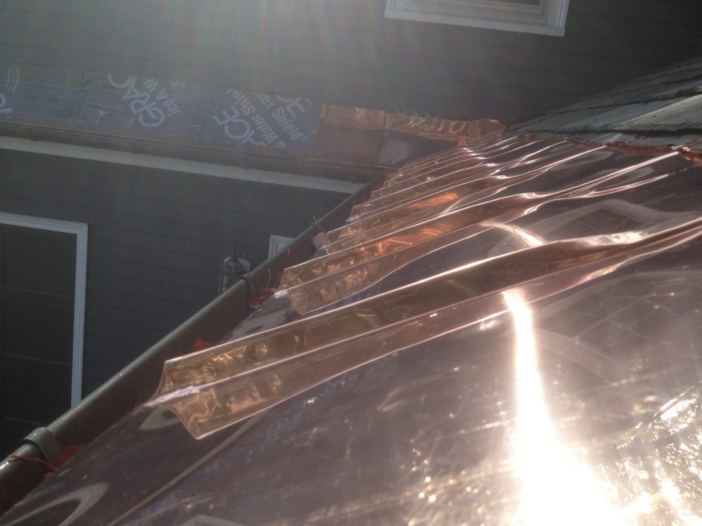 Landmark Roofing installing custom copper panel roofing for a home.