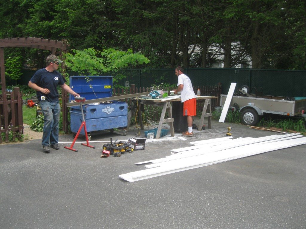 Landmark Roofing team installing roof ice rails for winter safety.