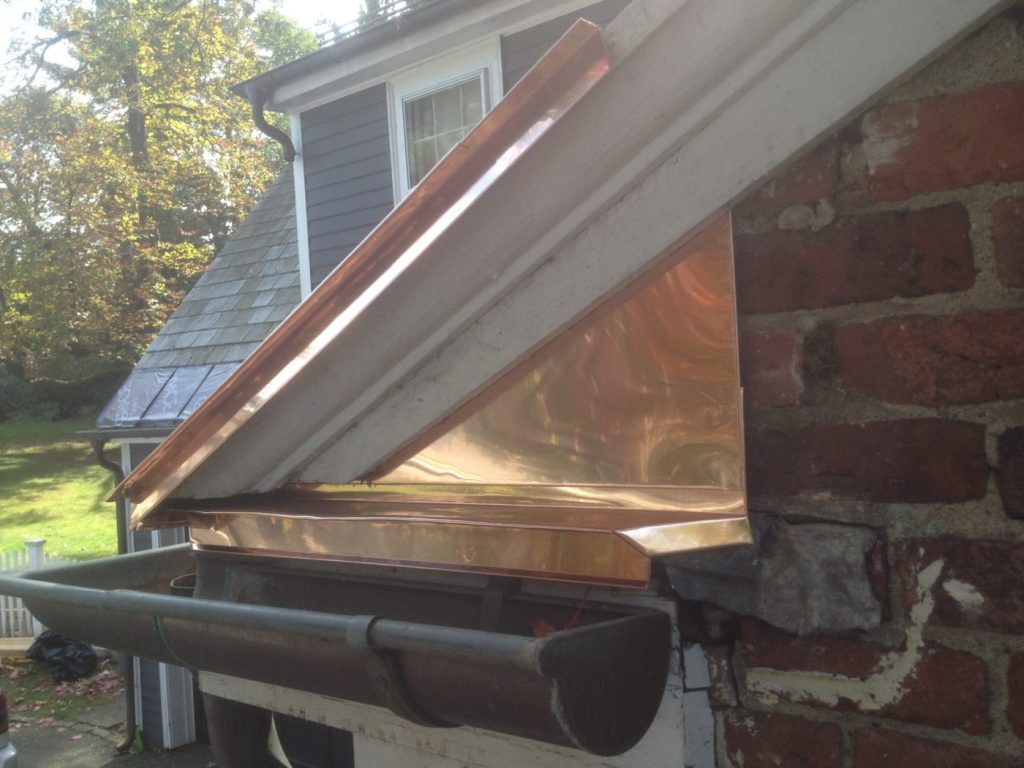 Close-up of copper panel roof installation by professional roofing contractors.