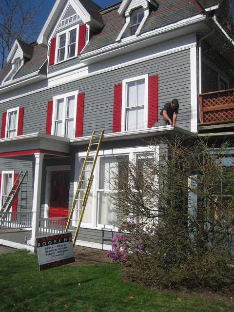 Residential flat roof with durable aluminum gutters installed by Landmark Roofing.