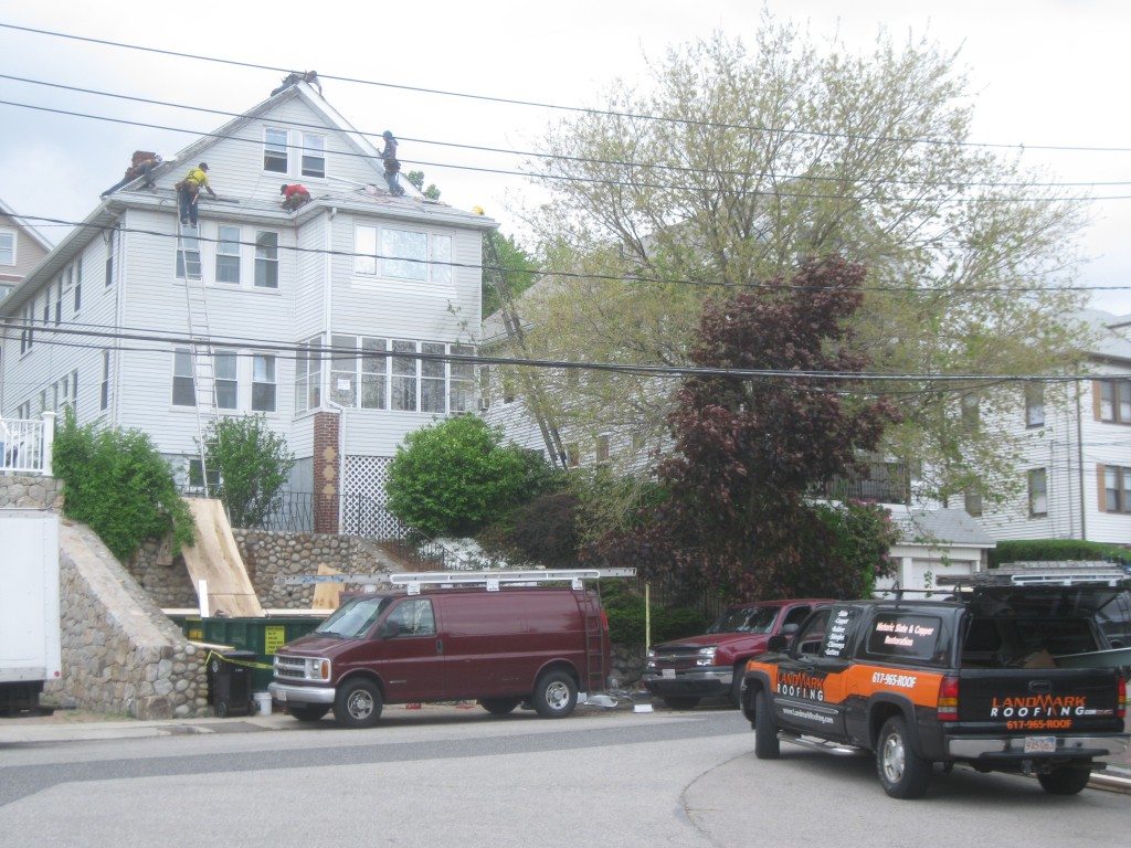 Technician performing roofing work in a confined space with precision and care.